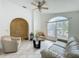 Inviting living room with tile floors, comfortable furniture, a ceiling fan, and natural light at 1034 Copenhagen Way, Winter Garden, FL 34787