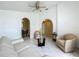 Spacious living room featuring tile flooring, comfortable seating, arched doorways, and access to other rooms at 1034 Copenhagen Way, Winter Garden, FL 34787