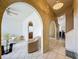 A stylish entryway with arched openings leads into a bright living room featuring tile floors and ample seating at 1034 Copenhagen Way, Winter Garden, FL 34787