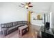 Comfortable living room with wood floors, a leather couch, and an open floor plan at 1034 Copenhagen Way, Winter Garden, FL 34787