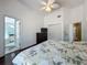 This light and airy main bedroom features hardwood floors, ceiling fan and ensuite bathroom access at 1034 Copenhagen Way, Winter Garden, FL 34787