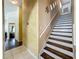 Staircase featuring brown wood and white risers, complemented by a golden accent wall at 1034 Copenhagen Way, Winter Garden, FL 34787