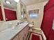 Cozy bathroom featuring classic fixtures, floral wallpaper, and a coordinated color scheme at 105 Avocado Cv, Leesburg, FL 34748
