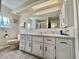 Bathroom with tile floor, large vanity, and large mirror at 105 Avocado Cv, Leesburg, FL 34748