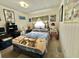 Cozy bedroom featuring a comfortable bed, charming decor and ample natural light at 105 Avocado Cv, Leesburg, FL 34748