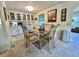 Charming dining area with a glass-top table, stylish chairs, and a view into the adjacent living spaces at 105 Avocado Cv, Leesburg, FL 34748