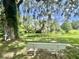 Secluded bench and tree provides a tranquil place to enjoy the water view at 105 Avocado Cv, Leesburg, FL 34748