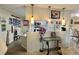 Open kitchen with a breakfast bar, and white cabinets at 105 Avocado Cv, Leesburg, FL 34748