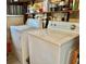 Washer and dryer with shelving in a utility room, providing a practical laundry solution at 105 Avocado Cv, Leesburg, FL 34748