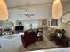 Cozy living room featuring plush seating, ceiling fan, and window at 105 Avocado Cv, Leesburg, FL 34748