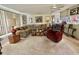 Cozy living room with neutral carpet, comfortable seating, and lots of decor at 105 Avocado Cv, Leesburg, FL 34748