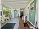 Inviting covered porch with multiple entrances, offering a warm welcome to the home at 105 Avocado Cv, Leesburg, FL 34748