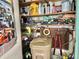 Cluttered storage area with shelves filled with various items and tools at 105 Avocado Cv, Leesburg, FL 34748