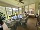 Relaxing sunroom with patio table set, perfect for enjoying leisure time with serene views of the lush outdoor scenery at 105 Avocado Cv, Leesburg, FL 34748