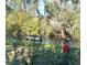 Scenic view of the river, a boat, trees, and a lamp post on a clear, sunny day at 105 Avocado Cv, Leesburg, FL 34748