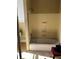 Bathroom with a white tub, yellow walls, and worn fixtures, presenting a renovation opportunity at 110 S Trowell Ave, Umatilla, FL 32784