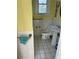 Cozy bathroom featuring white tile walls, pedestal sink, and vintage-style fixtures at 110 S Trowell Ave, Umatilla, FL 32784