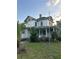 Exterior of a two-story home with a covered front porch and classic architectural details needing a bit of TLC at 110 S Trowell Ave, Umatilla, FL 32784