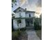 Image of a two-story home with a covered front porch and traditional design awaiting restoration at 110 S Trowell Ave, Umatilla, FL 32784