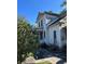 Side view of a home with access to a covered porch and steps to the backyard at 110 S Trowell Ave, Umatilla, FL 32784