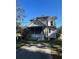 Charming multi-story home featuring a classic facade and spacious front yard at 110 S Trowell Ave, Umatilla, FL 32784