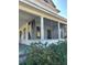 Classic home featuring a screened front porch with charming architectural columns at 110 S Trowell Ave, Umatilla, FL 32784