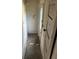 Hallway featuring a small window, graffiti on the wall, and a worn floor at 110 S Trowell Ave, Umatilla, FL 32784