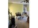 Open-concept living room with carpet, yellow walls, and furniture at 110 S Trowell Ave, Umatilla, FL 32784