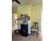 Living room featuring yellow walls, carpeted floors, and a decorative fireplace at 110 S Trowell Ave, Umatilla, FL 32784