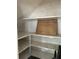 Storage area featuring wooden shelves, white painted woodwork, and an organized layout at 110 S Trowell Ave, Umatilla, FL 32784