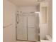 Bathroom featuring glass shower doors and a convenient towel rack at 1108 Apple Ter, Leesburg, FL 34748