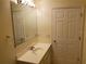 Bathroom featuring a well-lit vanity area with a large mirror and a clean, simple design at 1108 Apple Ter, Leesburg, FL 34748