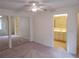 Carpeted bedroom with closet and an en-suite bathroom featuring a single sink vanity at 1108 Apple Ter, Leesburg, FL 34748