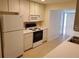 Bright kitchen with white appliances and tile flooring at 1108 Apple Ter, Leesburg, FL 34748