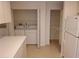 Dedicated laundry area includes a washer and dryer, along with additional storage space and shelving at 1108 Apple Ter, Leesburg, FL 34748