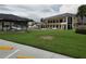Community pool area with lawn furniture and clubhouse, offering a refreshing outdoor recreation space and social amenities at 1108 Apple Ter, Leesburg, FL 34748