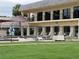 View of the community pool surrounded by lounge chairs and a protective fence, ensuring a safe and enjoyable recreation area at 1108 Apple Ter, Leesburg, FL 34748