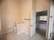 Bathroom featuring tile flooring, a toilet, and a view into an adjacent room through an open doorway at 1180 Mesa Verde Ct, Clermont, FL 34711