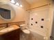 Bathroom featuring tile accents, a shower-tub combo, and a granite-topped vanity at 1180 Mesa Verde Ct, Clermont, FL 34711