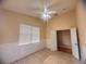 Bright bedroom with tile flooring, a ceiling fan, and a window with white blinds at 1180 Mesa Verde Ct, Clermont, FL 34711