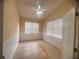 Well-lit bedroom with tile flooring, a ceiling fan, and a window with white blinds at 1180 Mesa Verde Ct, Clermont, FL 34711
