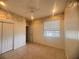 Cozy bedroom featuring tile flooring, a ceiling fan, and a window for natural light at 1180 Mesa Verde Ct, Clermont, FL 34711
