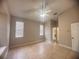 Spacious bedroom with neutral walls, tile flooring, a ceiling fan, and multiple windows providing natural light at 1180 Mesa Verde Ct, Clermont, FL 34711