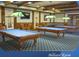 Inviting billiard room featuring three pool tables with overhead lighting, creating an ideal recreational space at 1180 Mesa Verde Ct, Clermont, FL 34711