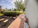 Charming walkway lined with decorative pots and lush landscaping leading to the home's entrance at 1180 Mesa Verde Ct, Clermont, FL 34711
