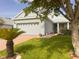 Charming single-story home with a well-manicured lawn, lush landscaping, and a brick-paved driveway at 1180 Mesa Verde Ct, Clermont, FL 34711