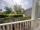 Cozy front porch view, showcasing manicured hedges, lush greenery, and serene neighborhood ambiance at 1180 Mesa Verde Ct, Clermont, FL 34711