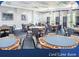 Well-lit game room with multiple octagonal tables and comfortable chairs, perfect for cards and board games at 1180 Mesa Verde Ct, Clermont, FL 34711