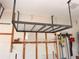 Garage featuring ceiling mounted storage racks and wall mounted storage and tool hanging at 1180 Mesa Verde Ct, Clermont, FL 34711
