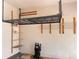 Garage featuring ceiling mounted storage racks and shelving units to maximize storage capacity at 1180 Mesa Verde Ct, Clermont, FL 34711